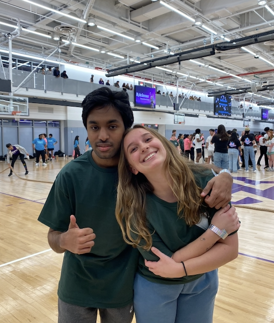 Two NYU students standing on a basketball court at NYU during the All-University Games.